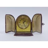 Miniature French gilt metal travelling alarm clock with a leather case, 8cm high