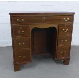 Mahogany kneehole desk, rectangular top with moulded edge over an arrangement of seven drawers, with