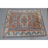 Kazak type rug with terracotta field and geometric motifs, 182 x 135cm