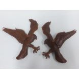 A pair of leather eagle wall plaques, 35cm (2)