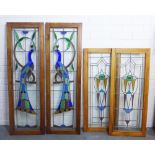 Two pairs of leaded coloured glass panels, one set depicting peacocks, wooden framed, 39 x 123 &