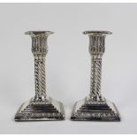 Pair of Victorian silver candlesticks, each with a detachable scone, leaf and spiral stems,