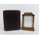 Parquetry mantle clock, with a brass handle to top, the brass movement numbered 754, with leather