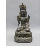 Bronze Buddha modelled seated in contemplative pose upon a lotus base, with gilt highlights, 24cm