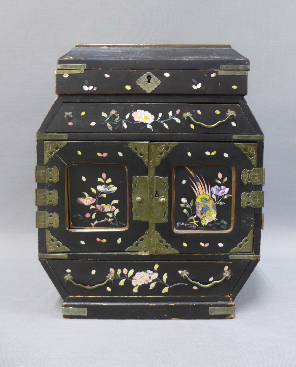 Japanese lacquered jewellery box with a hinged lid over a single long drawer and pair of cupboard