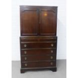 Mahogany bookcase cabinet, with a pair of cupboard doors, shelved interior and pullout slide over