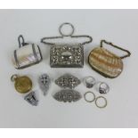 A collection of costume jewellery, coin holder and three early 20th century purses to include