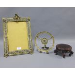 Two brass frames, one rectangular, 40 x 30cm, the other circular and a chinoiserie stand, (3)