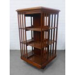 Mahogany revolving bookcase of typical form, on tripod stand with castors, 102 x 54cm