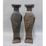 Pair of Japanese bronze vases, pierced handles and with figures, fish and dragons, signed, on square