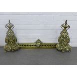 Pair of brass fire dogs and an associated brass fender (3)