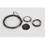 An early coin, silver baby's bangle and two silver rings, (4)