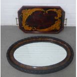 Early 20th century stained mahogany tray with brass handles and an oval framed wall mirror, (2)