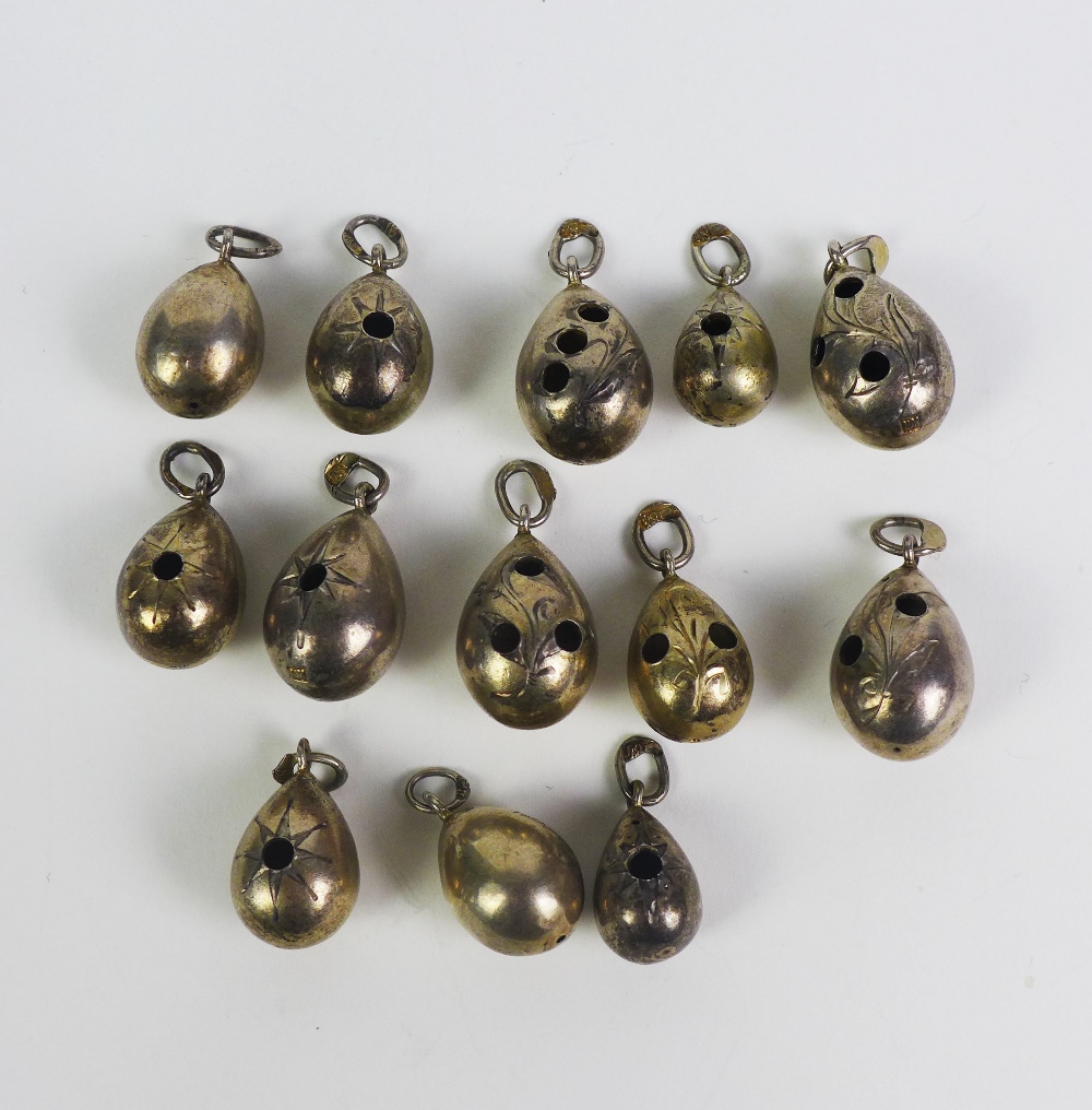 A collection of thirteen Russian pre- Revolutionary silver egg pendants with makers marks (13)