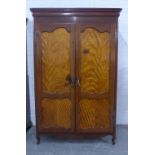 French style mahogany and satinwood two door wardrobe, with a brass hanging rail and hooks to the
