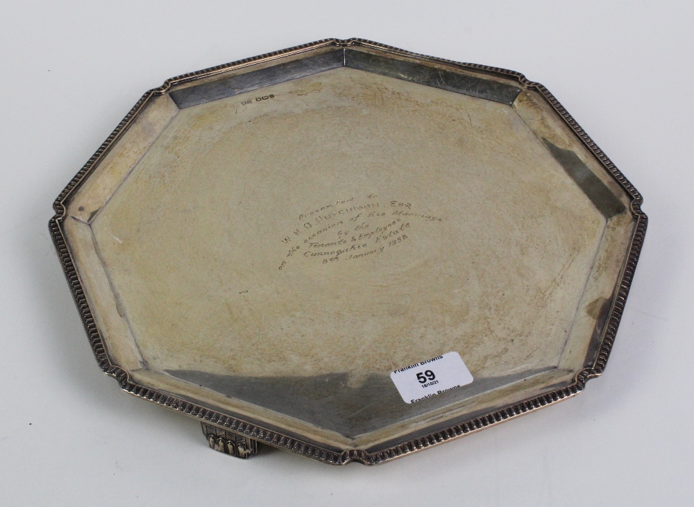 An octagonal silver presentation tray with gadrooned edge and Art Deco feet, by Walker & Hall,