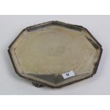 An octagonal silver presentation tray with gadrooned edge and Art Deco feet, by Walker & Hall,