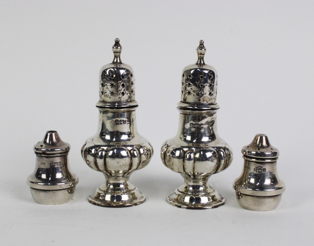 A pair of late Victorian silver pepper pots, in the form of miniature castors, Walker & Hall,