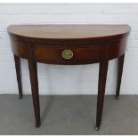 Mahogany fold over tea table, with a frieze drawer and square tapering legs terminating on brass