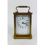 Small brass and glass panelled carriage clock, 14cm high including handle