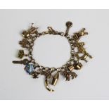 9ct gold charm bracelet hung with a collection of mainly 9ct gold charms, overall weight approx 28g