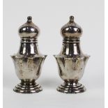 A pair of Edwardian silver pepper pots, Birmingham 1910, (2)