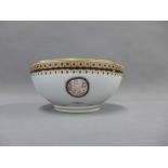 Porcelain punch bowl, the interior with birds and with a blue and gilt border, on a gilt lined