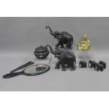 Collection of ebony wooden items to include a troop of elephants, hand mirror, glove stretchers