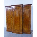 19th century burr walnut triple door wardrobe, the breakfront cornice with foliate carved frieze,