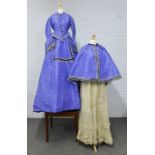 Late Victorian lady's long skirt, bodice jacket and cape all in purple and black dash fabric with