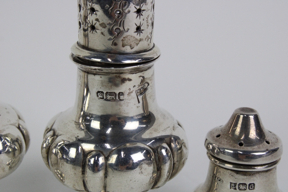 A pair of late Victorian silver pepper pots, in the form of miniature castors, Walker & Hall, - Image 2 of 3
