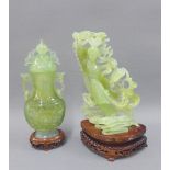 Jadeite jar and cover and a carved figure, with hardwood stands, tallest 20cm (2)