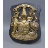 MacLean bronze family crest on an ebonised shield back, signed Mal Wilkinson, 26cm