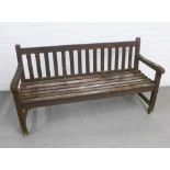 Weathered wooden garden bench with slatted back and seat, 153 x 84 x 56cm.