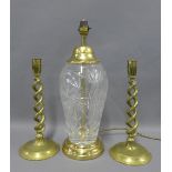 A pair of spiral stemmed brass candlesticks and a glass and faux brass table lamp base, (3)