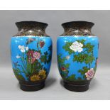 Pair of early 20th century cloisonne vases with flower, butterfly and foliage pattern to a blue