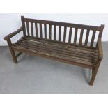 Weathered wooden garden bench with slatted back and seat 153 x 84 x 56cm.