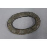 Nigerian Yoruba bronze anklet with a pattern of faces and interlocking knots, 19cm wide