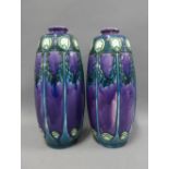 A pair of Minton Ltd No1. art nouveau vases, purple ground with blue and green slip trail pattern,