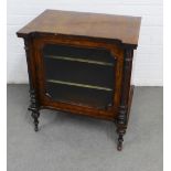 Late 19th century walnut music cabinet, with two interior shelves, a glazed door, ceramic casters