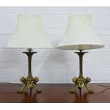 A pair of brass column table lamps, with tripod legs terminating on pad feet, with pleated shades,
