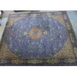 Large wool rug, the blue field with antelopes, lions and tigers, foliate spandrels and arabic