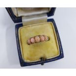 Yellow metal coral and diamond ring, with five coral cabouchon within a surround of nine old cut