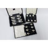 Cased sets of silver spoons to include two sets of six coffee bean handled spoons and a set of six