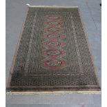 Pakistan rug, beige field with a row of seven guls within multiple geometric borders, 159 x 99cm