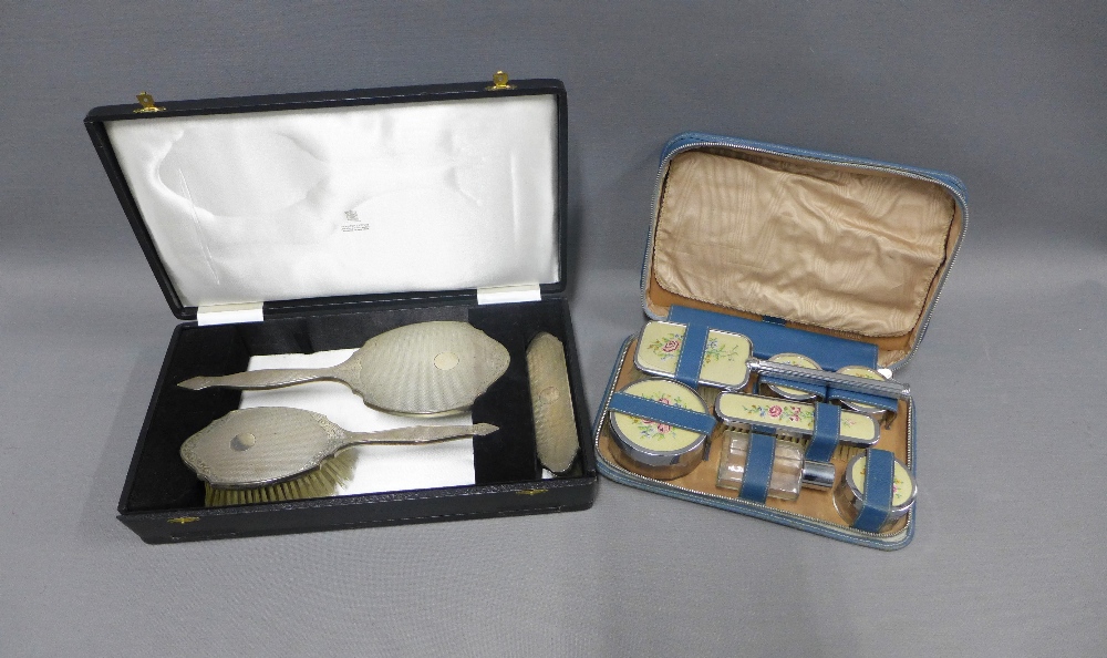 Early 20th century white metal backed dressing table brush set and a chrome dressing table brush set