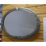 Arts & Crafts style pewter framed wall mirror with an oval glass plate, 62 x 48cm