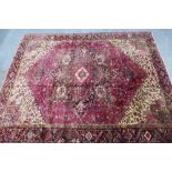 North West Persian Heriz carpet, red field with central medallion, angular foliage and flowerhead