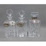 Silver mounted cut glass spirit decanter and cover, two other glass decanters and stoppers,