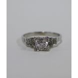 Diamond ring, with a claw set bright cut diamond with three further diamonds to the stepped